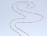 Assembly Ring Styled Pendant on a Long Silver Chain